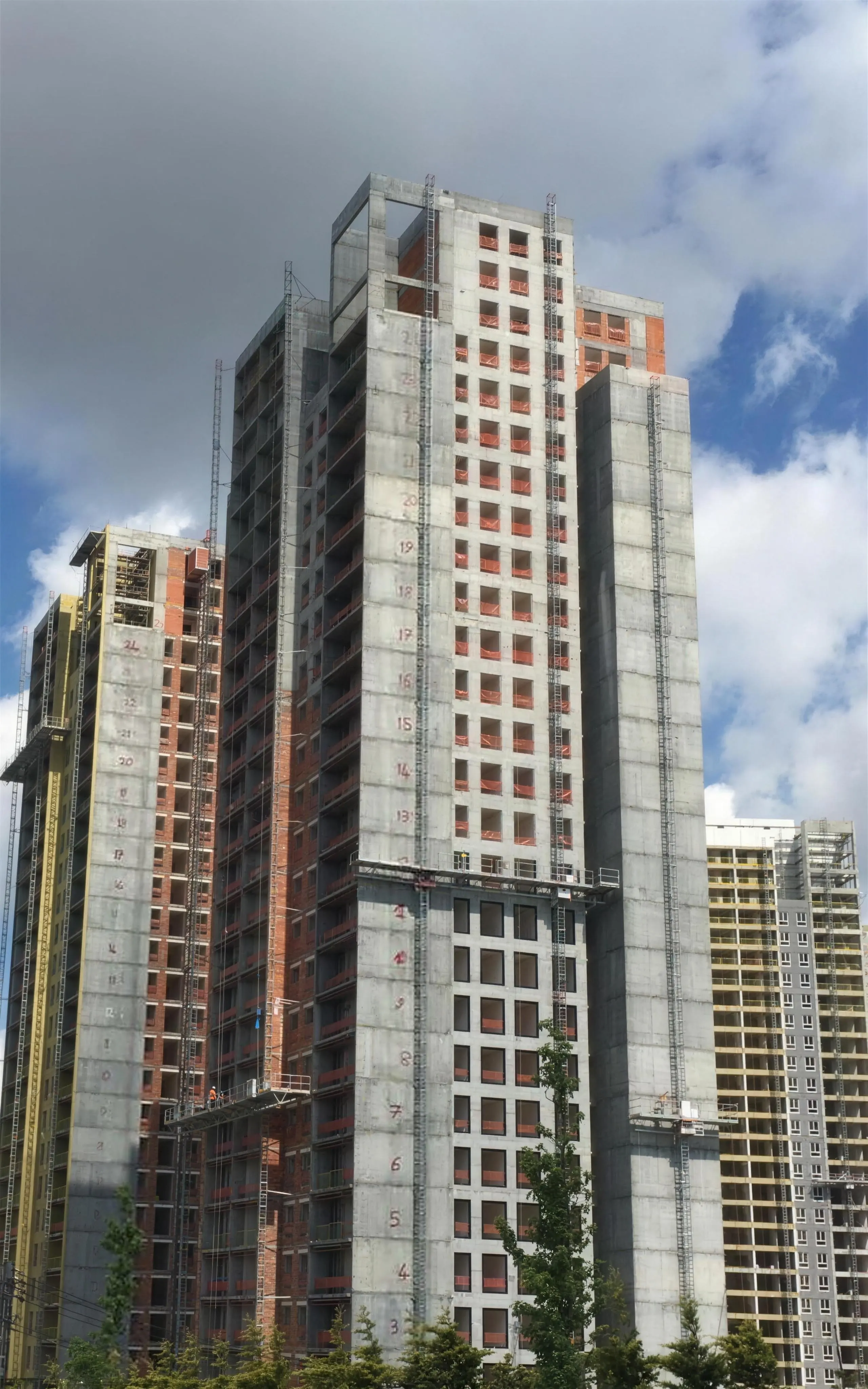 Mast climbing work platforms installed on the facades of high-rise residential towers